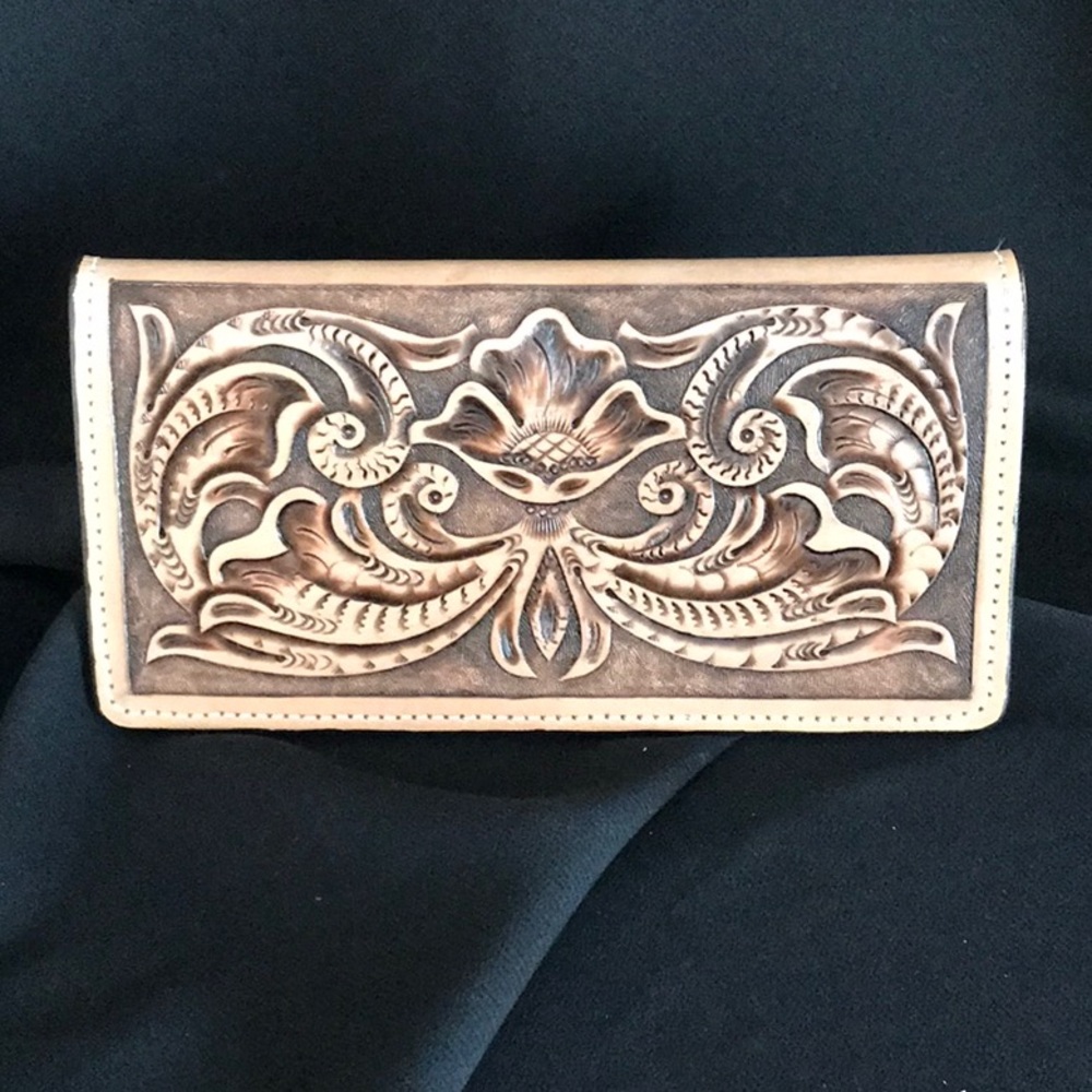 Leather hand tooled roper checkbook/wallet.